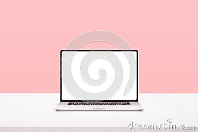 Laptop mockup on white desk with pastel pink background Stock Photo