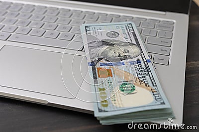 Laptop and money. buying laptop. unspent money on deposit in bank Stock Photo