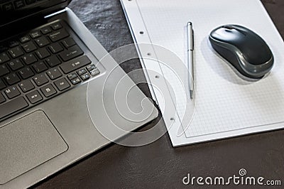 the laptop, the mouse, and the note pad Stock Photo