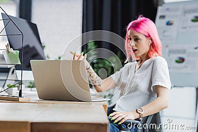 laptop near blurred businesswoman with pink Stock Photo