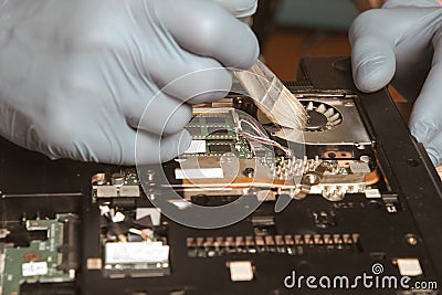 Laptop repair. Dust cleaning. An engineer cleans a computer. Stock Photo