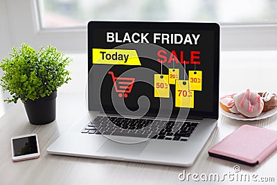 Laptop with sale black friday on screen and phone Stock Photo