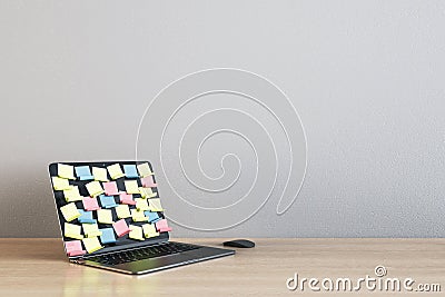 Laptop screen covered by colored sticker notes on light wooden table Editorial Stock Photo