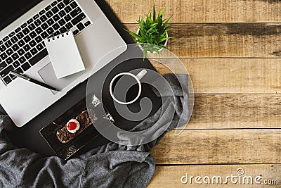 Laptop, small notebook and breakfast on wood background. Stock Photo