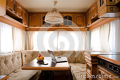 Laptop and smartphone on a table in the bright little kitchen Stock Photo