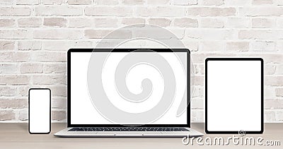 Laptop, tablet and phone mockup on work desk. Modern devices with thin, round edges Stock Photo