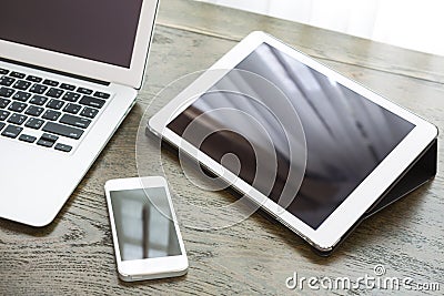 Laptop with tablet and smart phone on table Stock Photo
