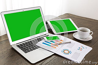 Laptop, tablet , smartphone with financial financial documents Editorial Stock Photo