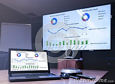 Laptop and television with presentation slideshow in meeting room Stock Photo