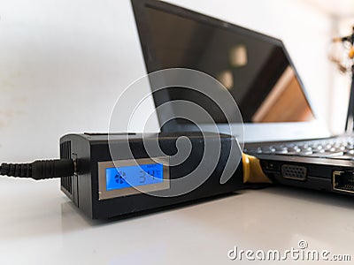 Laptop with Vacuum Cooler Attached to Laptop Air Vent Stock Photo