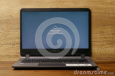 The laptop with windows update on screen. Its offers increased security in the operating system Editorial Stock Photo