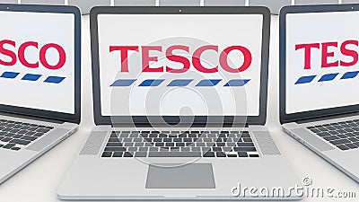 Laptops with Tesco logo on the screen. Computer technology conceptual editorial 3D rendering Editorial Stock Photo