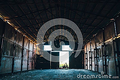 Large abandoned empty and dirty rusty iron hangar, creepy warehouse inside Stock Photo