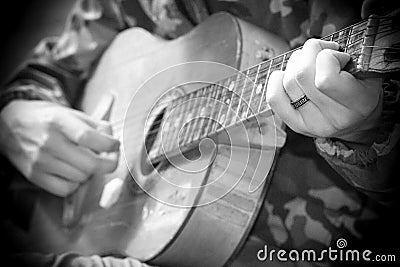 A large acoustic old guitar in the hands Stock Photo