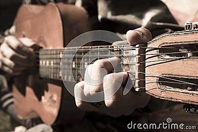 A large acoustic old guitar in the hands Stock Photo