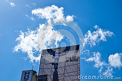 A large advertising billboard in a hotel rooftop against blue cloudy sky Editorial Stock Photo