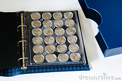 Large album for collectible coins in capsules Stock Photo