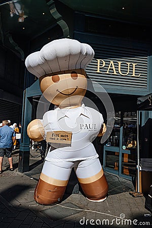 Large announcement - Free hugs sticker on large chef air statue next to the Editorial Stock Photo