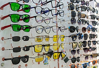 A large assortment of different glasses on a shelf in an optics store Editorial Stock Photo
