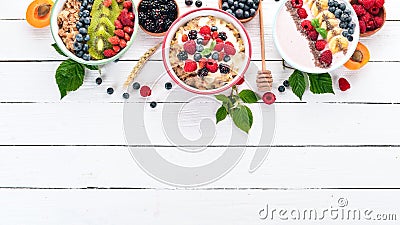 Large Assortment of porridge with fruit and berries. Breakfast. On a white wooden background. Stock Photo