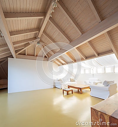 Large attic with wooden ceiling Stock Photo