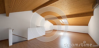 Large attic with wooden floors and exposed beams Stock Photo