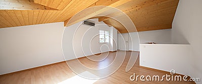 Large attic with wooden floors and exposed beams Stock Photo