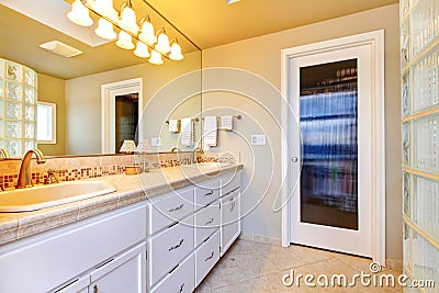 Large bathroom with white cabinets Stock Photo