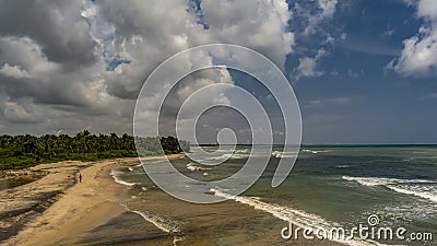 Large Beach with solitary man walking Stock Photo