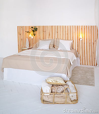 Large bed with beige pillowcases and white pillows Stock Photo