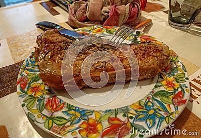 A large beef steak was cooked and seasoned with rosemary Stock Photo