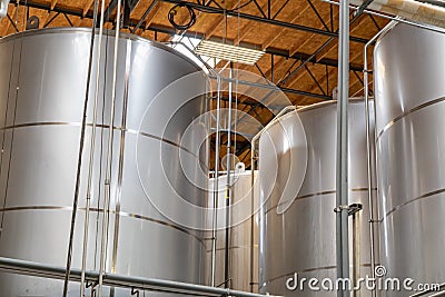 Large Beer Brewery Fermentation Tanks in Warehouse Stock Photo