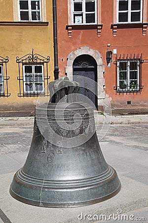 the large bell is displayed in front of the building with windows Editorial Stock Photo