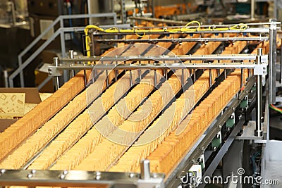 Large biscuit factory. A line of biscuits in a large factory. Packing crackers on the machine. Innovative production. Stock Photo