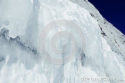 Large blocks of ice frozen waterfall or water. Icicles in the cave Stock Photo