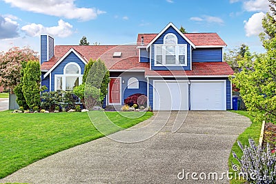 Large blue house with white trim and a nice lawn. Stock Photo