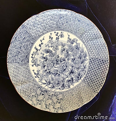 Large Blue and White Porcelain Charger with Intricate Patterns and Flowers Stock Photo