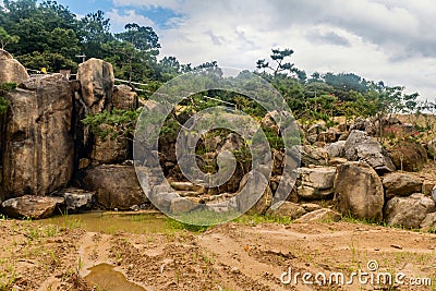 Large boulders arranged to create an artificial waterfall Stock Photo