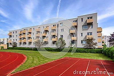 A large brick building with a athletic track Stock Photo