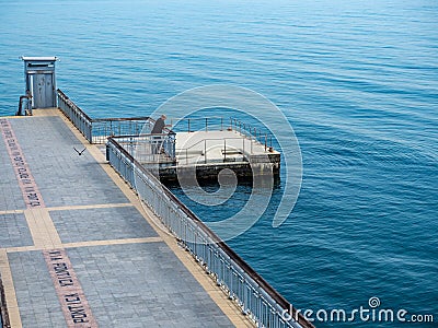 A large bridge with a pier and jumping and walking people in Burgas, Bulgaria Editorial Stock Photo