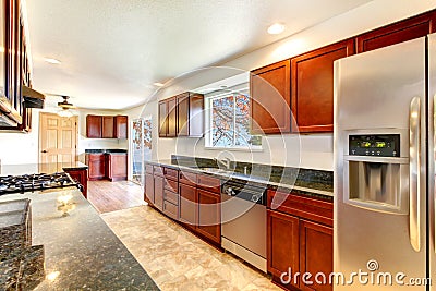 Large bright kitchen with dark cherry cabinets. Stock Photo