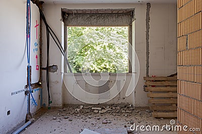 Large bright room with windows of an ancient villa undergoing renovation. The old walls have been torn down and new ones have been Stock Photo