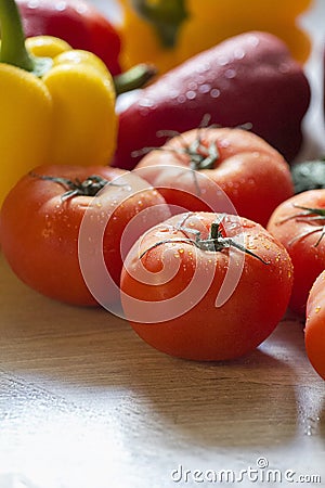 Large and bright tomatoes on the kitchen table Stock Photo