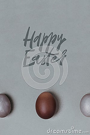 Large brown egg between small gray. easter minimalistic concept Stock Photo