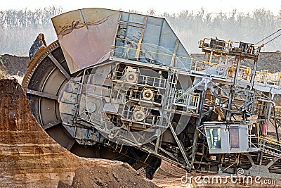 Large bucket wheel excavator mining machine at work in a brown coal open pit mine Stock Photo