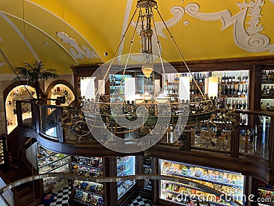 Large carved ceiling chandelier in a grocery store Editorial Stock Photo