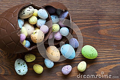 Large chocolate easter egg full of small candy Stock Photo
