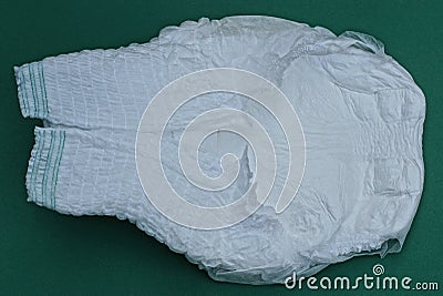 large clean white diaper lies on a green table Stock Photo