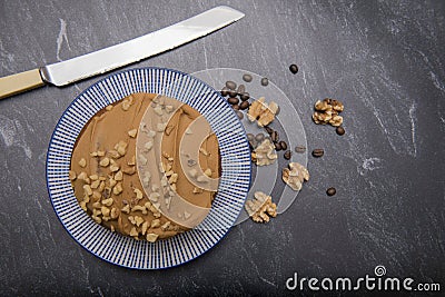 Large coffee and walnut cake on a dark background Stock Photo