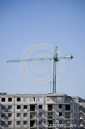 Large construction site cranes working on a building complex with clear blue sky Editorial Stock Photo